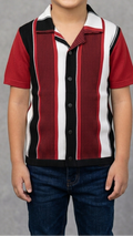 Child wearing a red, white, and black striped shirt against a gray background