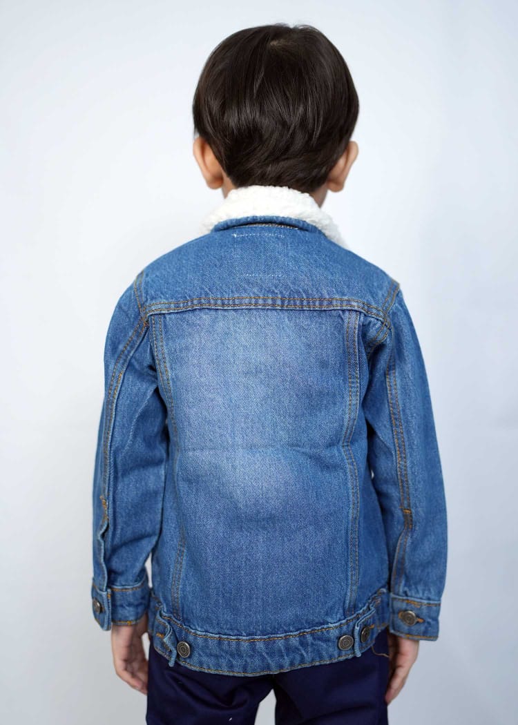 Child wearing a stylish mid blue denim jacket with a cozy collar, showcasing a playful and trendy look.