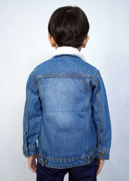 Child wearing a stylish mid blue denim jacket with a cozy collar, showcasing a playful and trendy look.